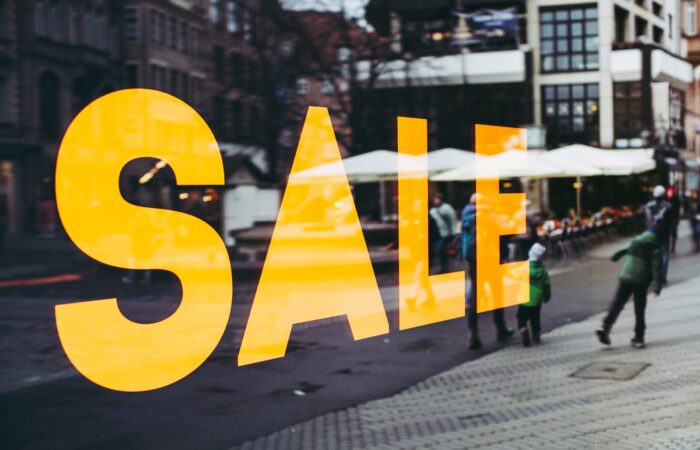 man in green jacket walking on sidewalk during daytime